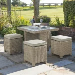 Palma Cube 4 wicker set in oyster with stone coloured cushions on a traditional garden patio in the sunshine