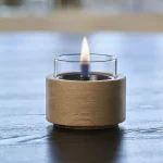 Tenderflame Lotus 10 with natural wood base on a table