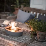 Tenderflame Carnation table top candle with concrete base on a table