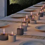 Long Table in the garden at night with lots of Breeze 10 Tenderflame candles in black and grey