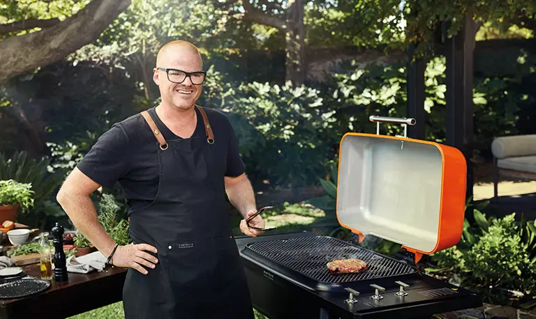 Heston Blumenthal cooking on a gas bbqs in the garden