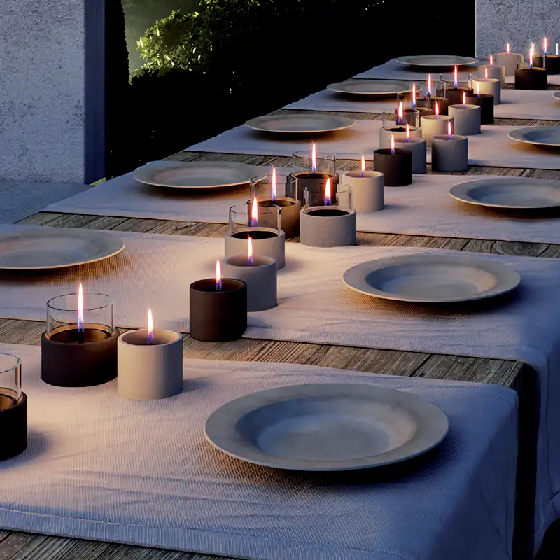 A collection of candles on a garden table