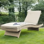 Universal Lounger in oyster with stone cushions on the grass in a garden