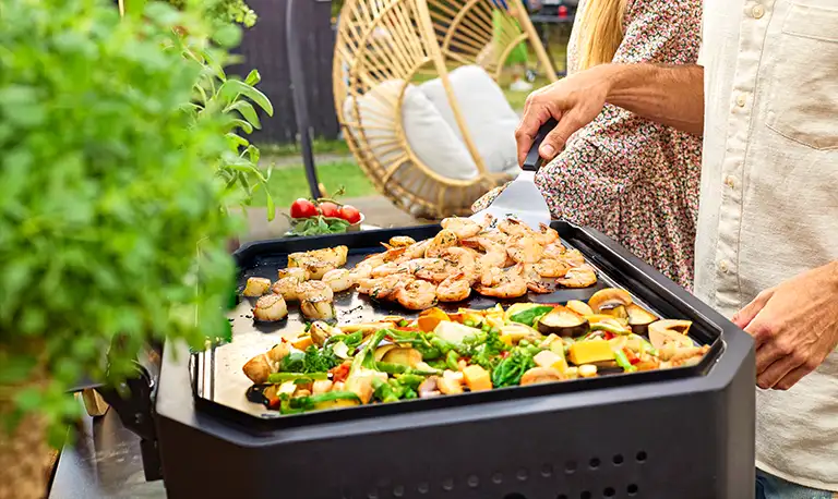 Cooking brunch on a Cozze plancha in the garden