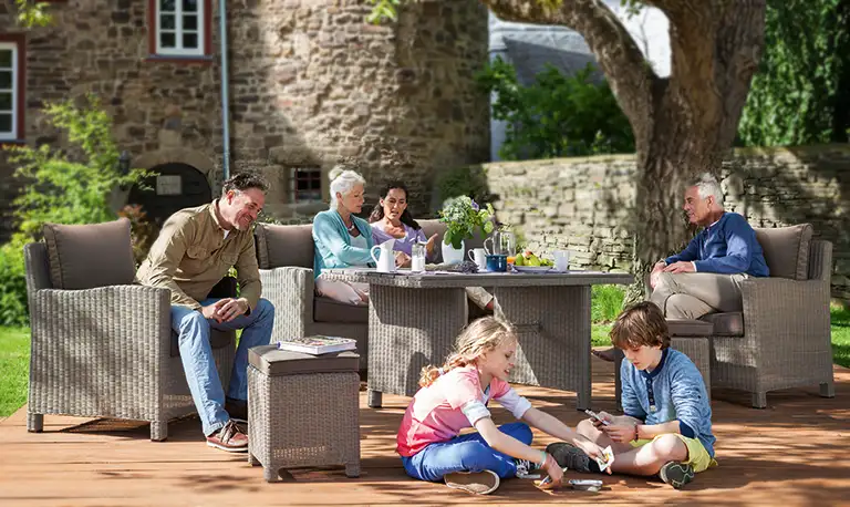 Old Palma sofa set in rattan with family having fun in the garden