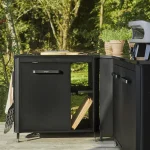 Cozze one door kitchen unit with shelf in a garden setting