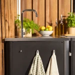 Side view of Cozze 2 door outdoor kitchen unit with sink and tap.